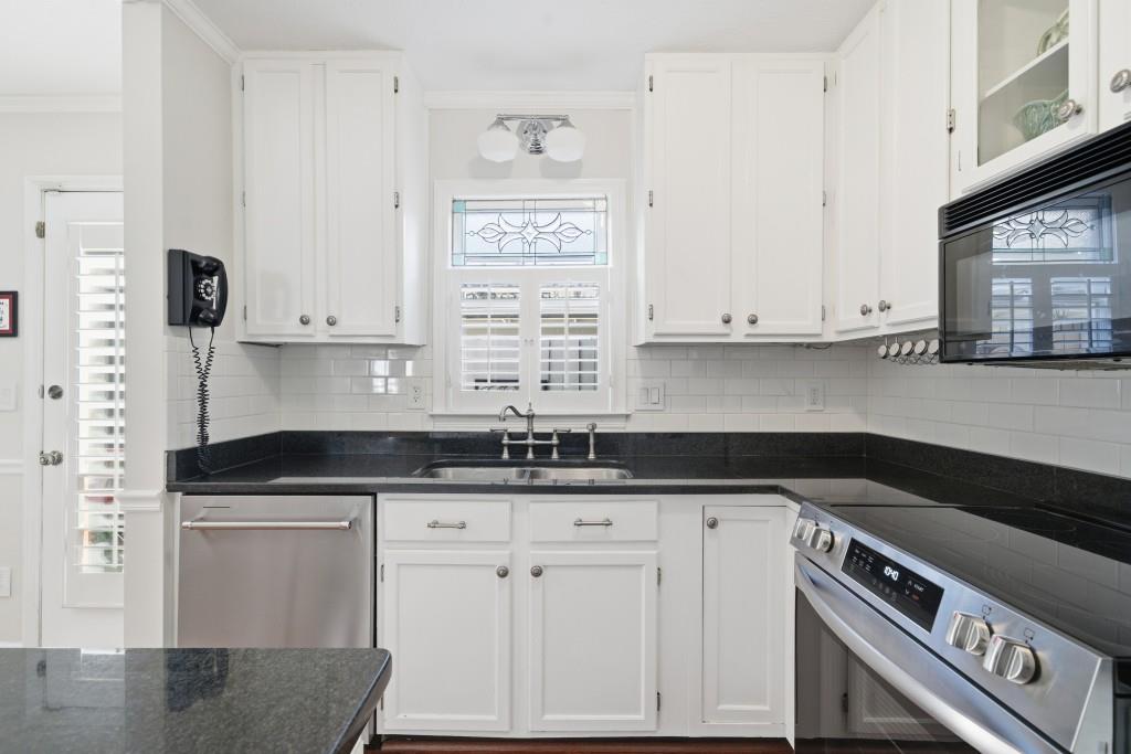 4138 Crape Myrtle Lane Duluth, GA 30096 - Photo 24 of 50 a kitchen with granite countertop white cabinets and sink