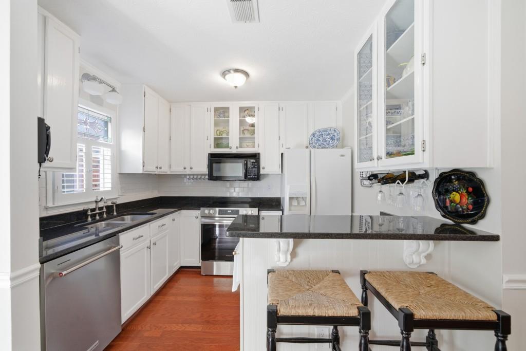 4138 Crape Myrtle Lane Duluth, GA 30096 - Photo 3 of 50 a kitchen with stainless steel appliances granite countertop a stove a sink and a refrigerator