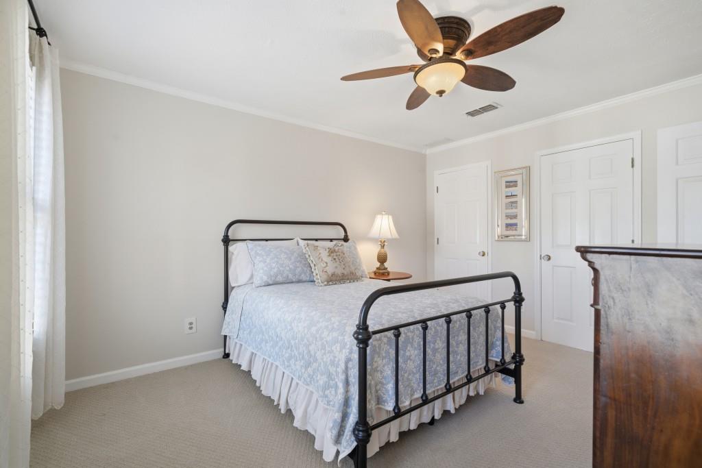 4138 Crape Myrtle Lane Duluth, GA 30096 - Photo 31 of 50 a bedroom with a bed and a ceiling fan