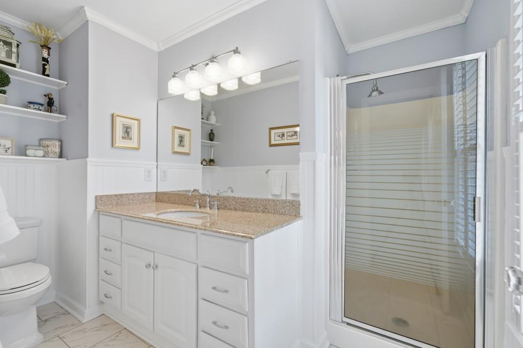 4138 Crape Myrtle Lane Duluth, GA 30096 - Photo 32 of 50 a bathroom with a granite countertop sink a toilet and a mirror