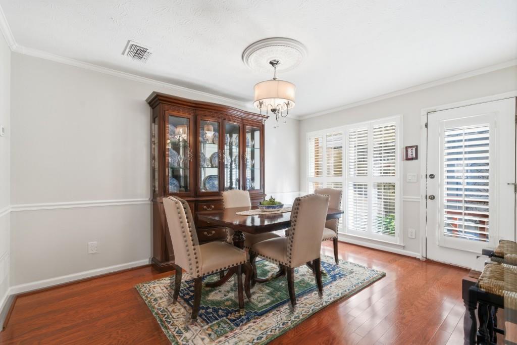 4138 Crape Myrtle Lane Duluth, GA 30096 - Photo 5 of 50 a dining room with wooden floor and a floor to ceiling window