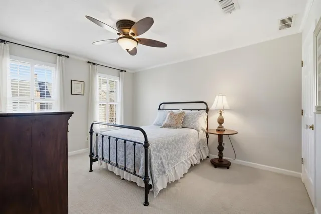 a spacious bedroom with a bed and a chandelier