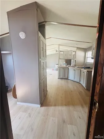 a view of empty room with wooden floor