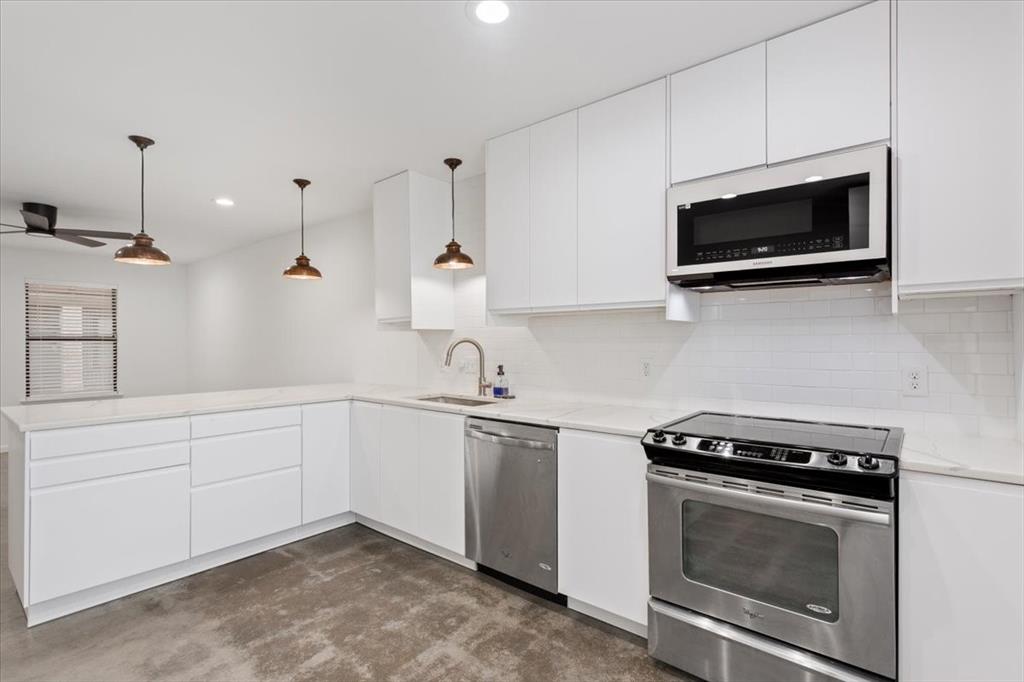 1326 South 12th Street Waco, TX 76706 - Photo 12 of 25 a kitchen with stainless steel appliances a stove microwave and sink