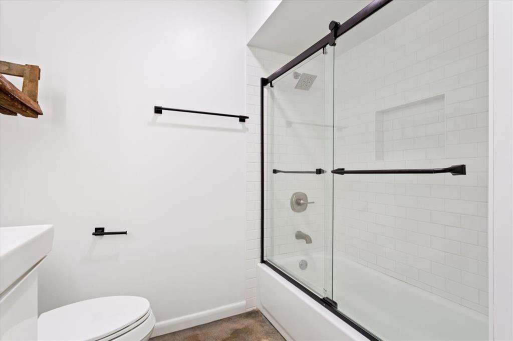 1326 South 12th Street Waco, TX 76706 - Photo 19 of 25 a bathroom with a toilet and a shower