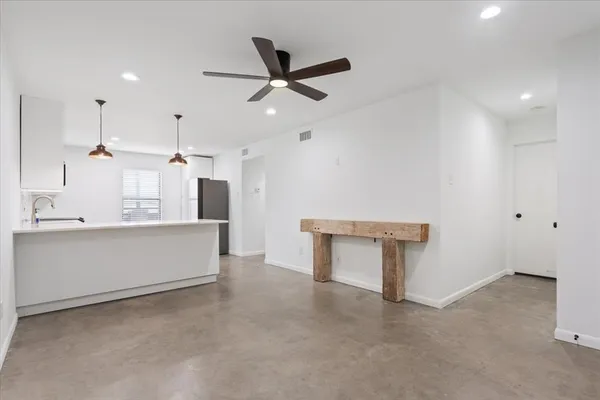 a view of kitchen with refrigerator sink and stove