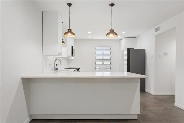 a kitchen with a sink and cabinets