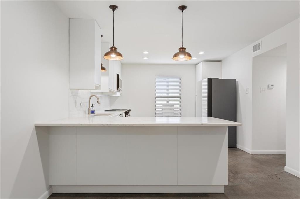 1326 South 12th Street Waco, TX 76706 - Photo 9 of 25 a room with kitchen island a sink and wooden floor