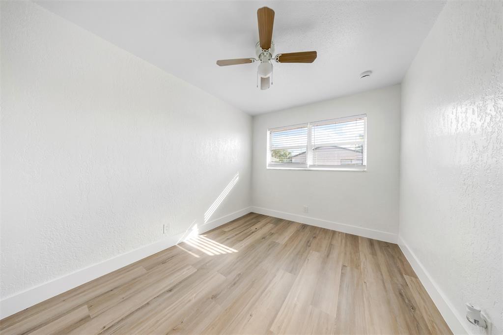 20 Northwest 7th Avenue Pompano Beach, FL 33060 - Photo 11 of 22 wooden floor in an empty room with a window