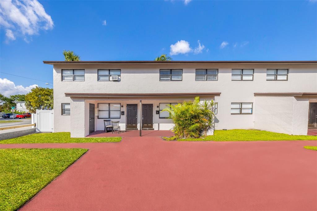 20 Northwest 7th Avenue Pompano Beach, FL 33060 - Photo 20 of 22 a front view of a house with a yard and table