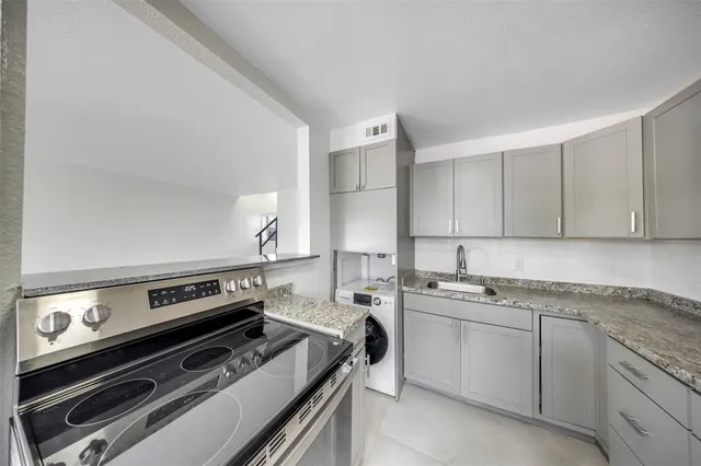 a view of a kitchen with a stove top oven