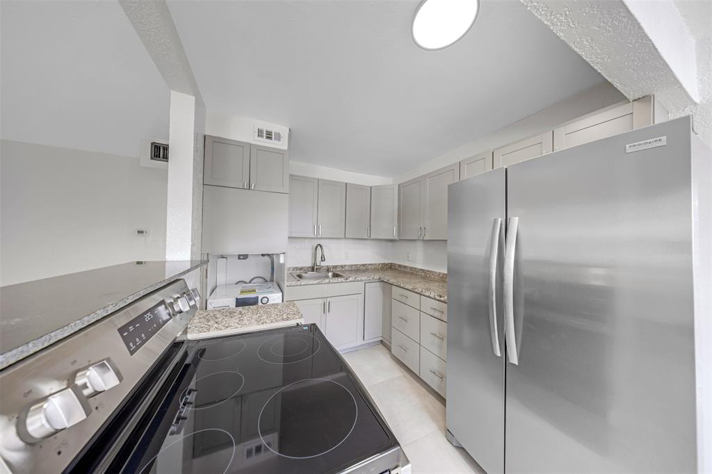 20 Northwest 7th Avenue Pompano Beach, FL 33060 - Photo 3 of 22 a kitchen with a sink appliances and cabinets