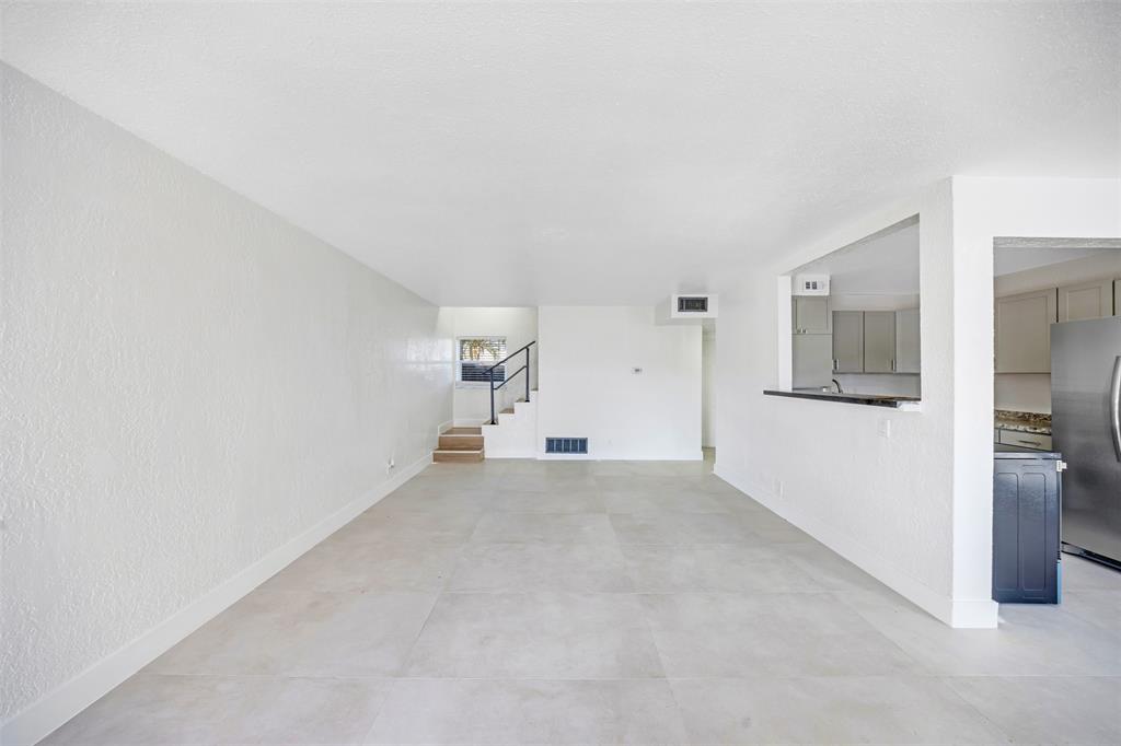 20 Northwest 7th Avenue Pompano Beach, FL 33060 - Photo 4 of 22 a view of a big room with closet and windows