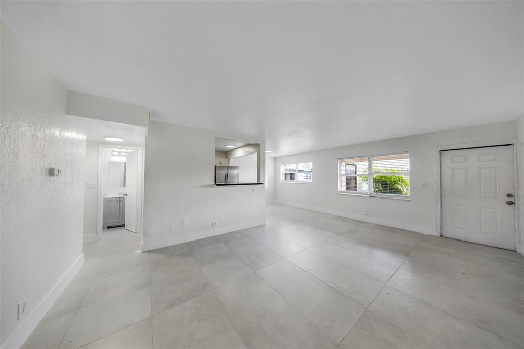 20 Northwest 7th Avenue Pompano Beach, FL 33060 - Photo 7 of 22 an empty room with windows and entrance