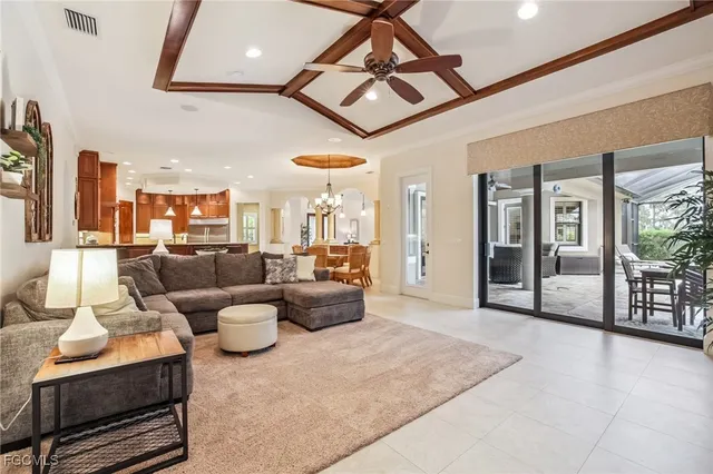 a living room with furniture and a view of kitchen