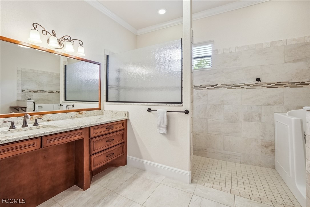 6041 Calusa Rdg Trail Bokeelia, FL 33922 - Photo 15 of 44 a bathroom with a double vanity sink a mirror and a shower
