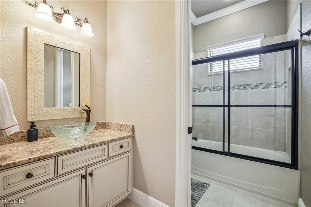 6041 Calusa Rdg Trail Bokeelia, FL 33922 - Photo 17 of 44 a bathroom with a granite countertop sink and a mirror
