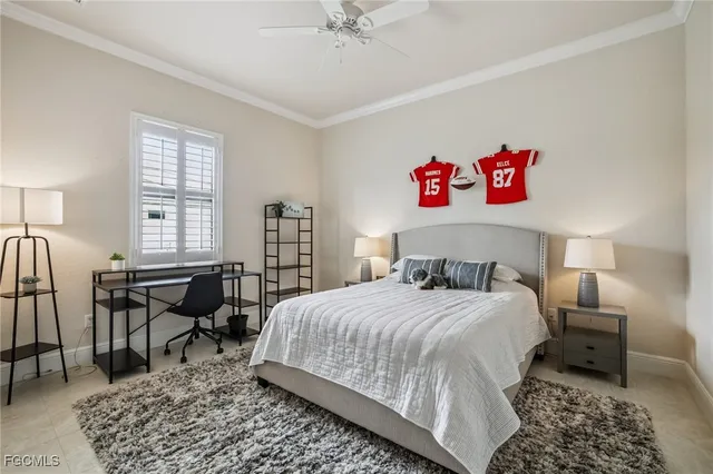 a bedroom with a bed a table and chair