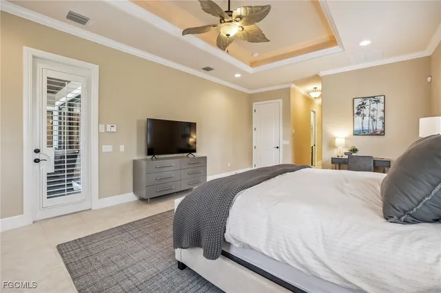 a bedroom with a bed a tv and couches