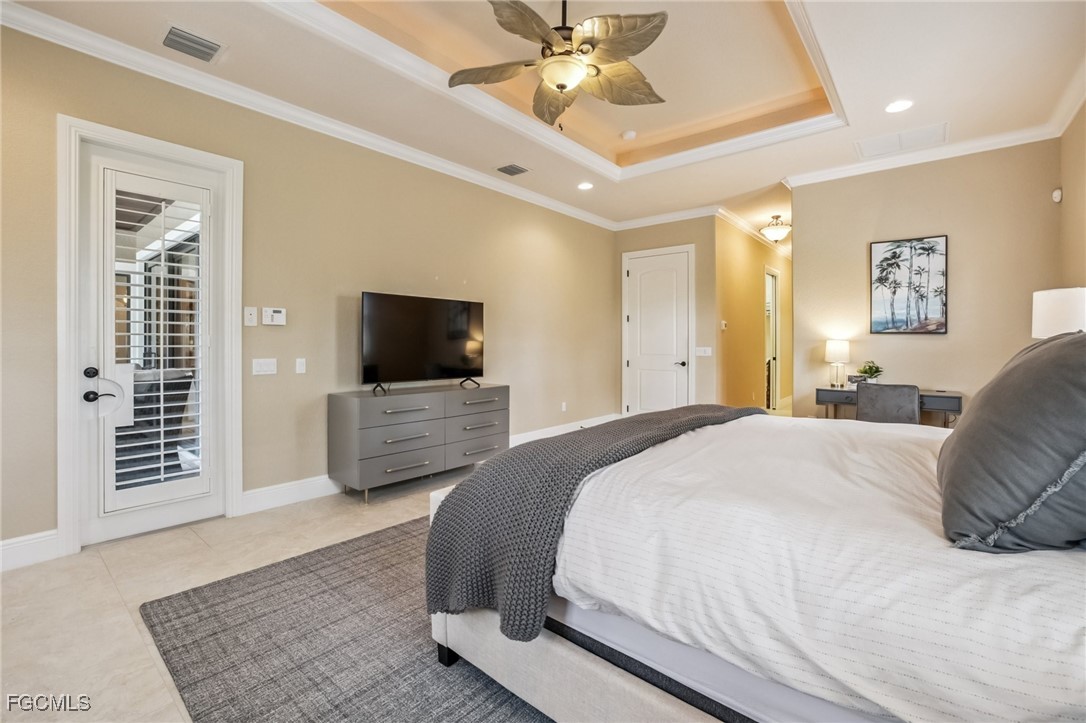 6041 Calusa Rdg Trail Bokeelia, FL 33922 - Photo 20 of 44 a bedroom with a bed a tv and couches