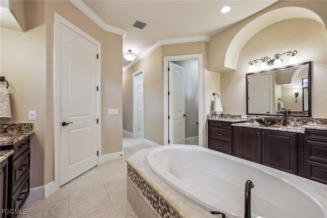 6041 Calusa Rdg Trail Bokeelia, FL 33922 - Photo 22 of 44 a large bathroom with a tub sink and mirror