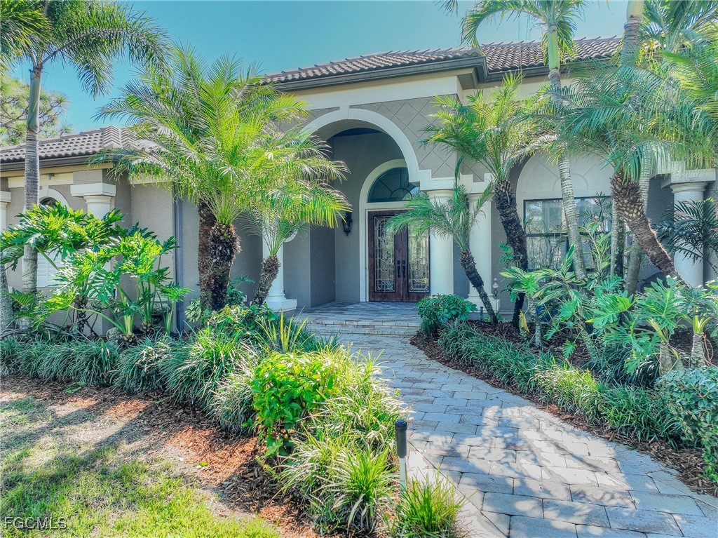 6041 Calusa Rdg Trail Bokeelia, FL 33922 - Photo 3 of 44 a front view of a house with garden