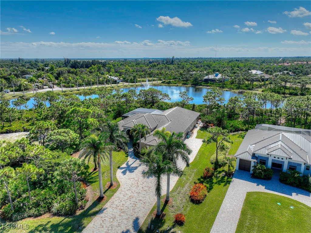 6041 Calusa Rdg Trail Bokeelia, FL 33922 - Photo 31 of 44 a view of a lake with a house in a yard