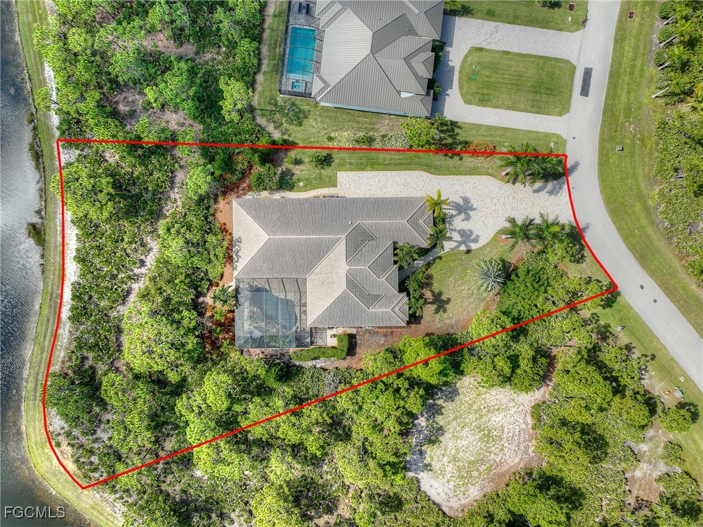 6041 Calusa Rdg Trail Bokeelia, FL 33922 - Photo 36 of 44 an aerial view of a house with a yard