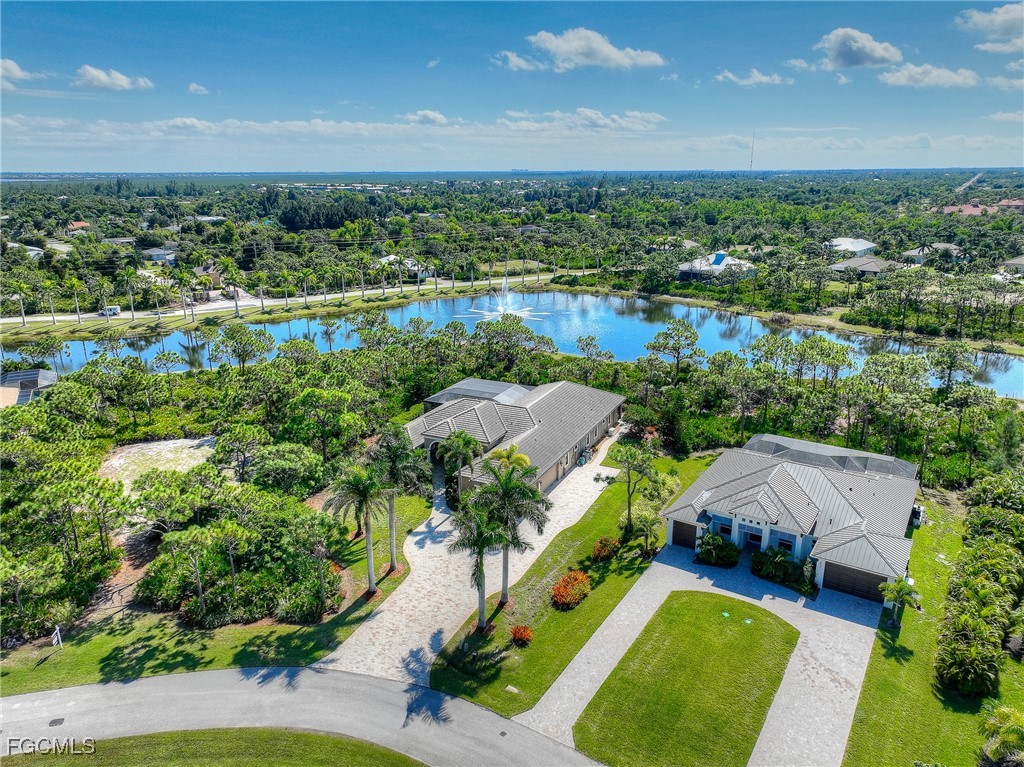 6041 Calusa Rdg Trail Bokeelia, FL 33922 - Photo 38 of 44 an aerial view of a house with a garden and lake view