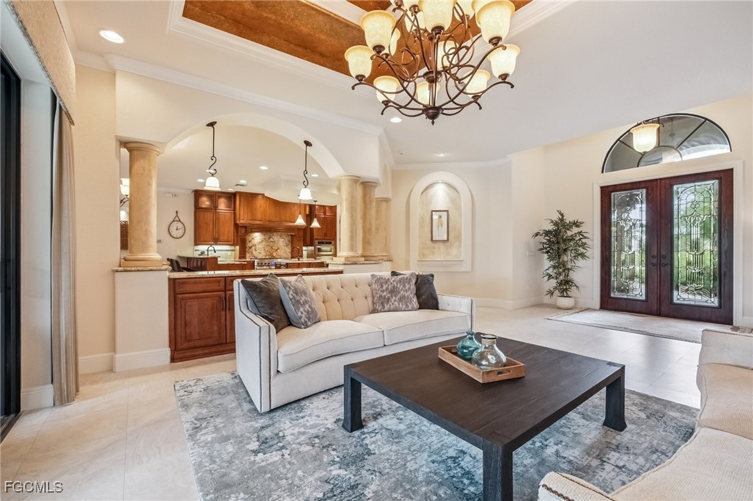 6041 Calusa Rdg Trail Bokeelia, FL 33922 - Photo 6 of 44 a living room with furniture a chandelier and a large window
