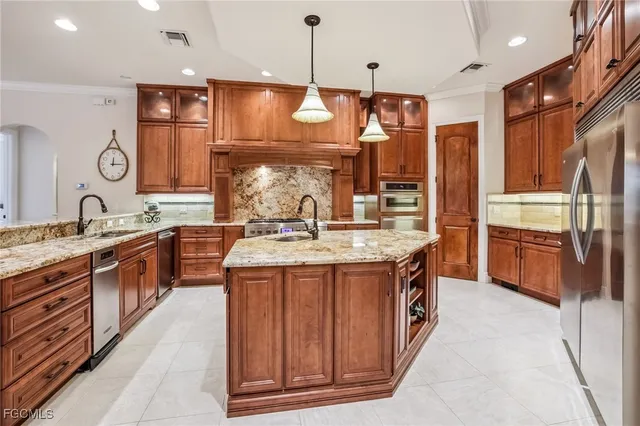 a kitchen with stainless steel appliances granite countertop wooden cabinets and sink