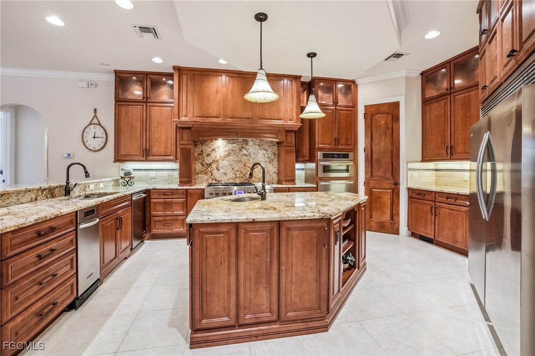 6041 Calusa Rdg Trail Bokeelia, FL 33922 - Photo 8 of 44 a kitchen with stainless steel appliances granite countertop wooden cabinets and sink