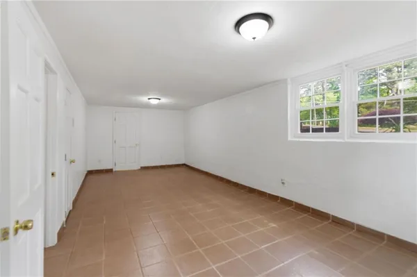 an empty room with a empty space and windows