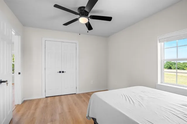 a bedroom with a bed and a window