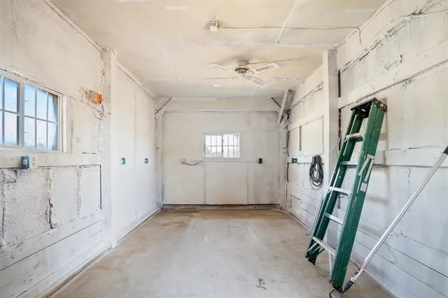 a view of a yard with wooden fence