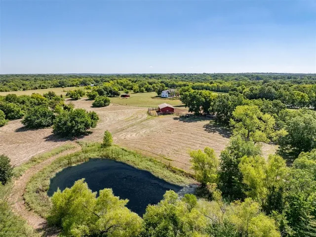 an aerial view of a house with a yard