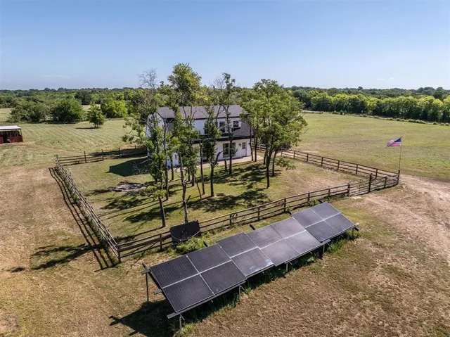 a view of a terrace with outdoor seating and trees in the background