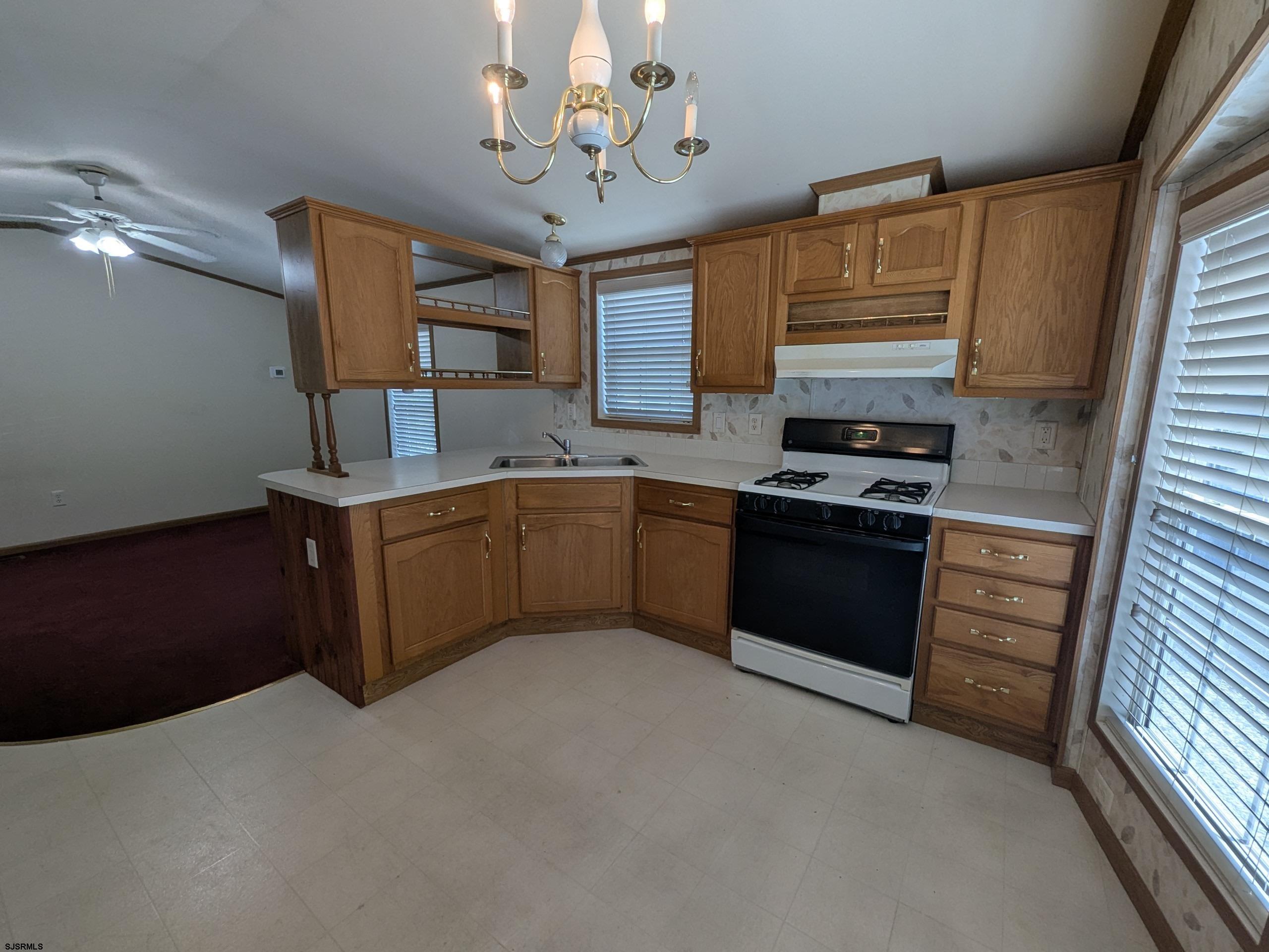 430 South Shore Road, Unit 21 Marmora, NJ 08223 - Photo 5 of 14 a kitchen with stainless steel appliances granite countertop a sink stove and refrigerator