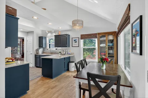 a view of kitchen with sink and refrigerator