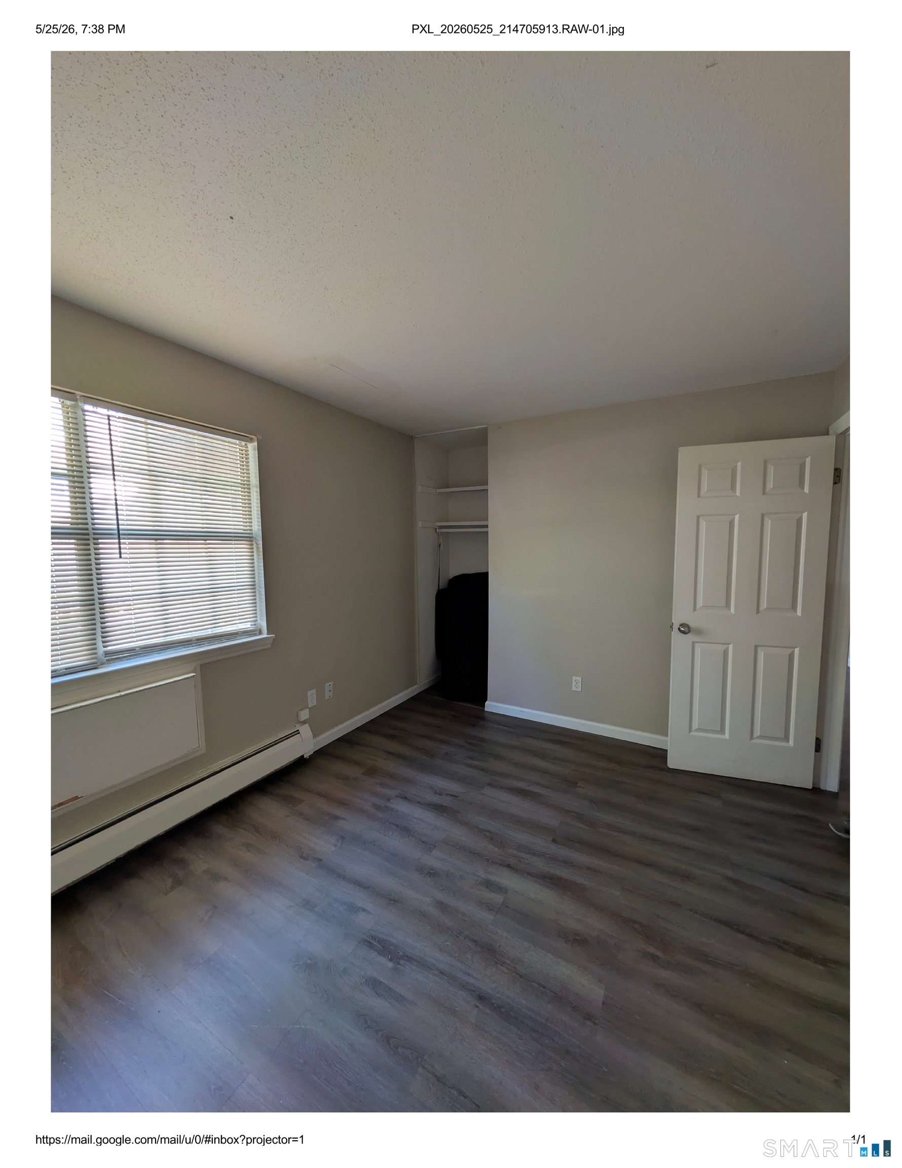 62 Angel Drive, Unit A Waterbury, CT 06708 - Photo 9 of 11 a view of an empty room with wooden floor and a window