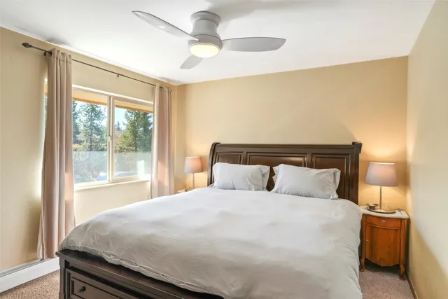 a bedroom with a large bed and a large window