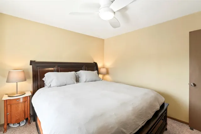 a bedroom with a bed and lamps