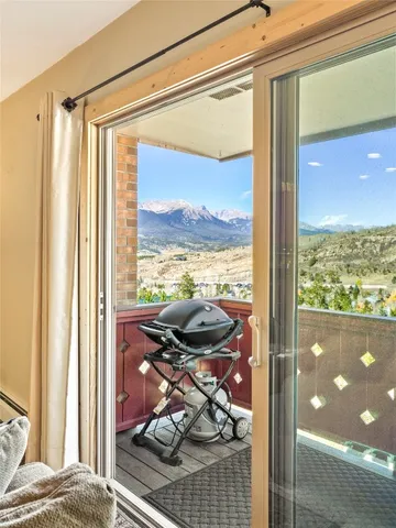 a view of a room with a bed and glass door