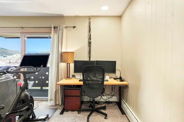 a view of workspace with wooden floor windows and piano