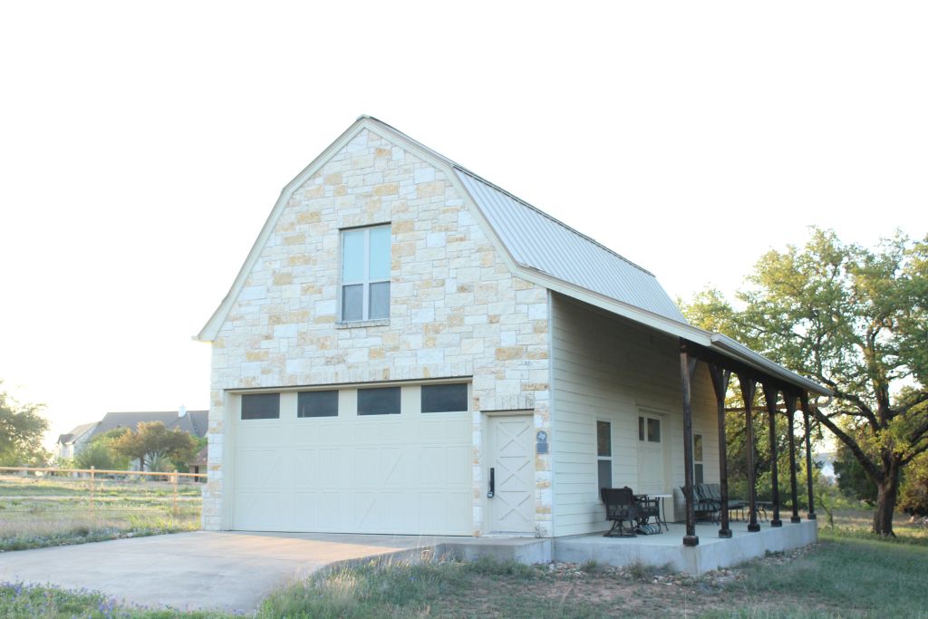 5300 Lookout Ridge Drive Marble Falls, TX 78654 - Photo 9 of 40 Barn garage door, covered porch, window in unfinished guest quarters