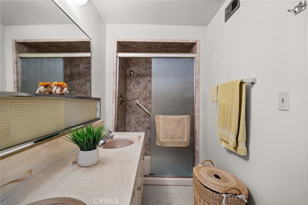 19514 Enslow Drive Carson, CA 90746 - Photo 17 of 51 a white vase with flowers and white cabinets