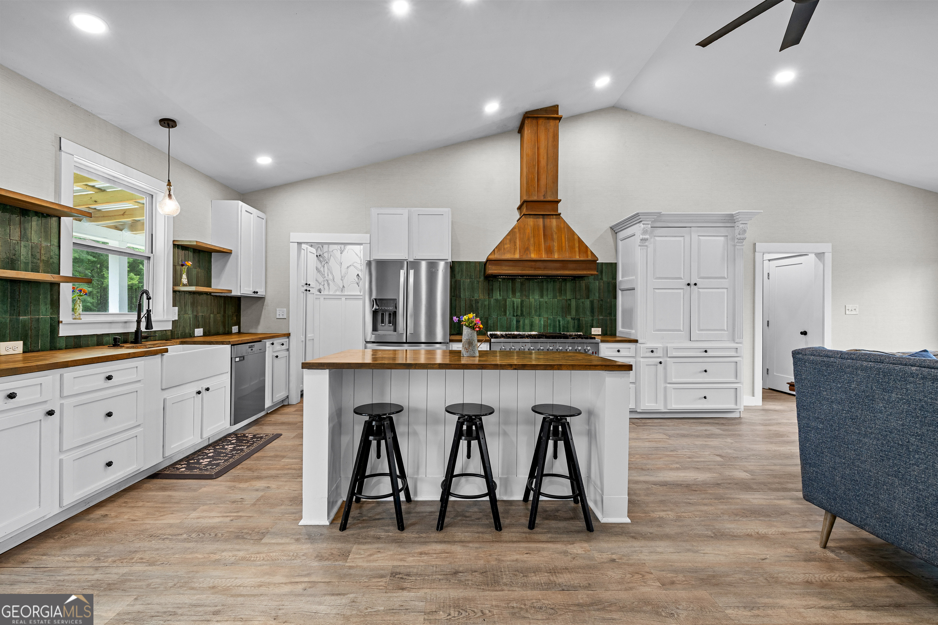 1329 Standing Rock Road Senoia, GA 30276 - Photo 8 of 77 a kitchen with granite countertop a table chairs sink refrigerator and microwave