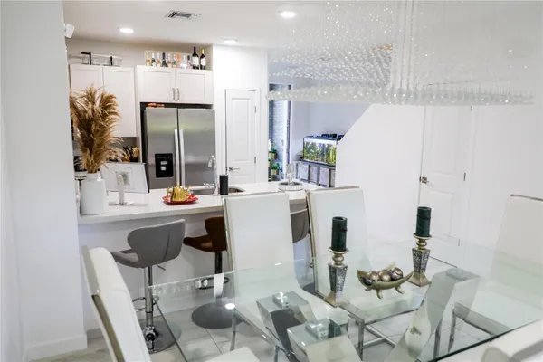 a dining room with furniture a large window and wood floor