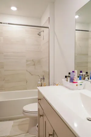 a bathroom with a sink a toilet and a bathtub