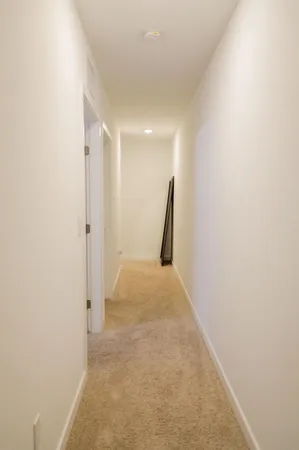 a view of hallway with a white wall